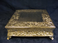 Ornate square silver stand